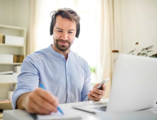 mature-businessman-with-headphones-and-laptop-indo-2022-02-02-03-59-12-utc.jpg